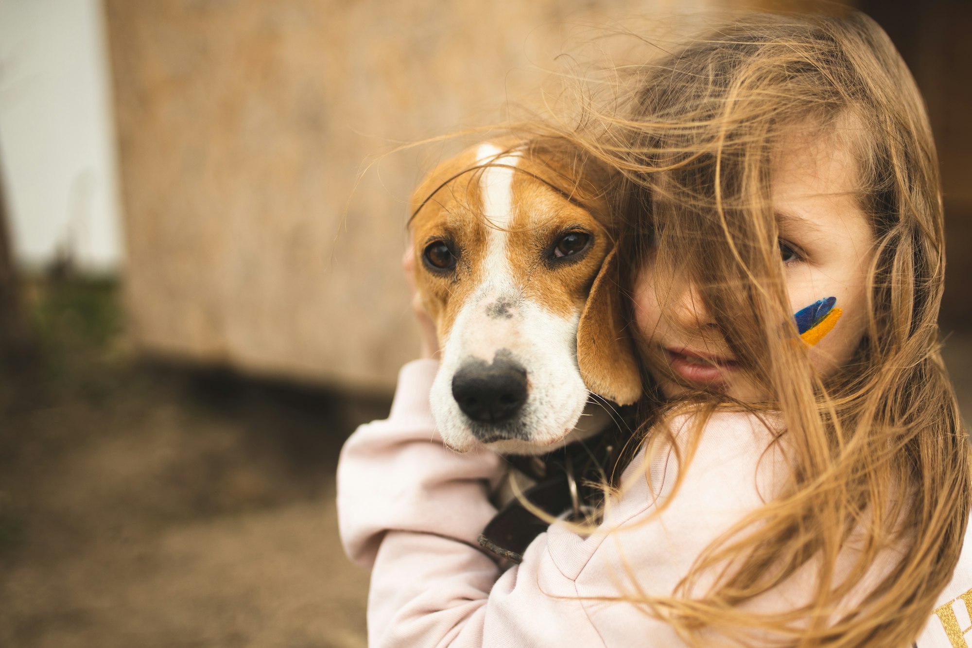 The girl protects her dog. A girl from Ukraine and her dog. Love for animals. Ukrainian child.