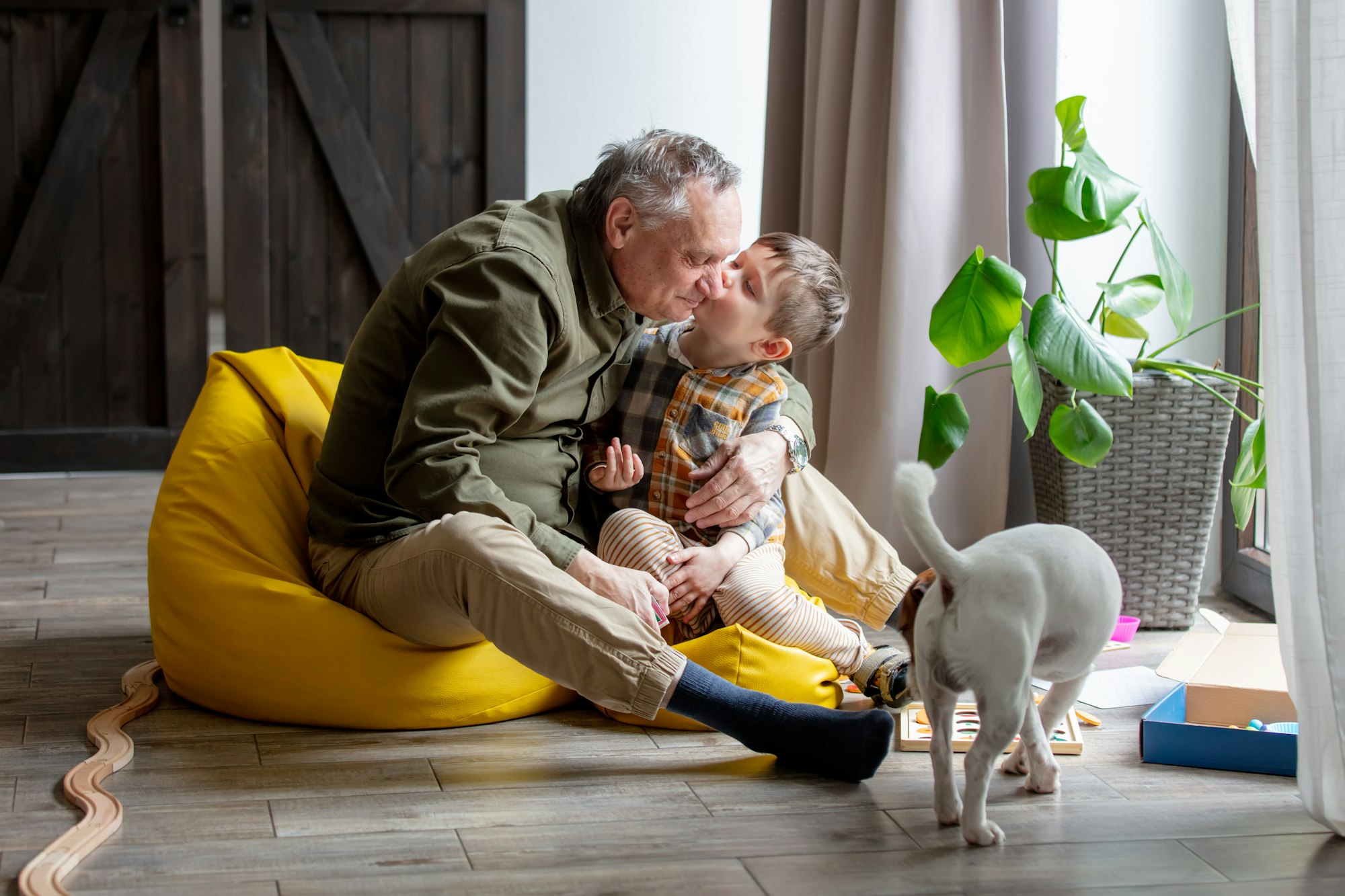 Ukrainian grandfather and grandson play together indoor